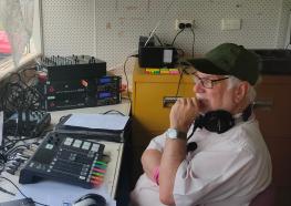Peter Crick 2ARM Station President and Former Co-manager, broadcasting outdoors at Armidale Show