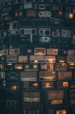 Collection of old radios stuck on top of each other