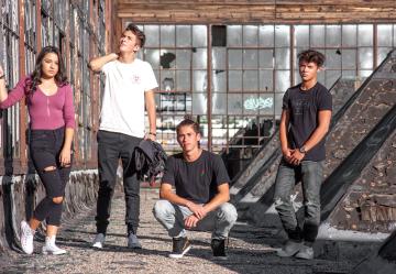 Photo of teenagers outside an abandoned warehouse